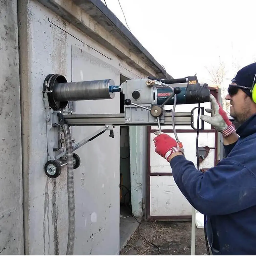 Bosch elmas uçlu karot delme makinesi beton duvara monte edilmiş — su soğutmalı sondaj uygulaması