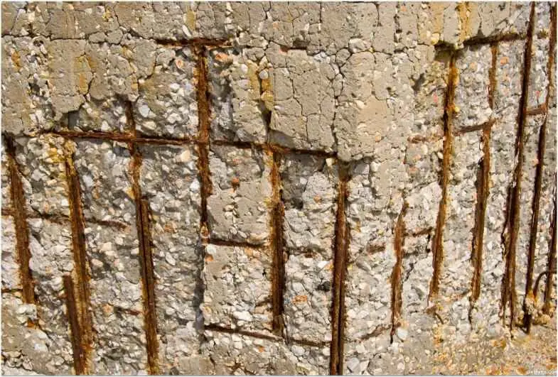 Eski bir beton yapıda yetersiz pas payı nedeniyle beton yüzeyi dökülmüş, donatı çubukları dışarıya çıkmış ve ağır korozyon (pas) oluşmuş bir kolon yüzeyi